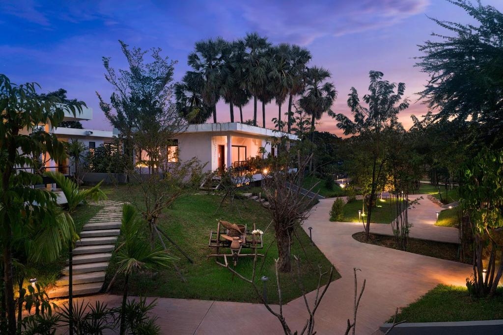 a house with a garden at dusk at Hillocks Hotel & Spa in Siem Reap