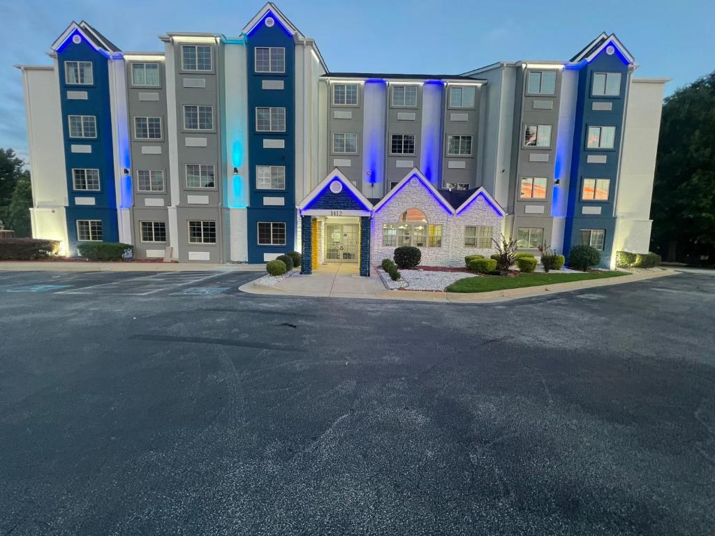 a large building with blue lights on the front of it at Micro Hotel in Conyers