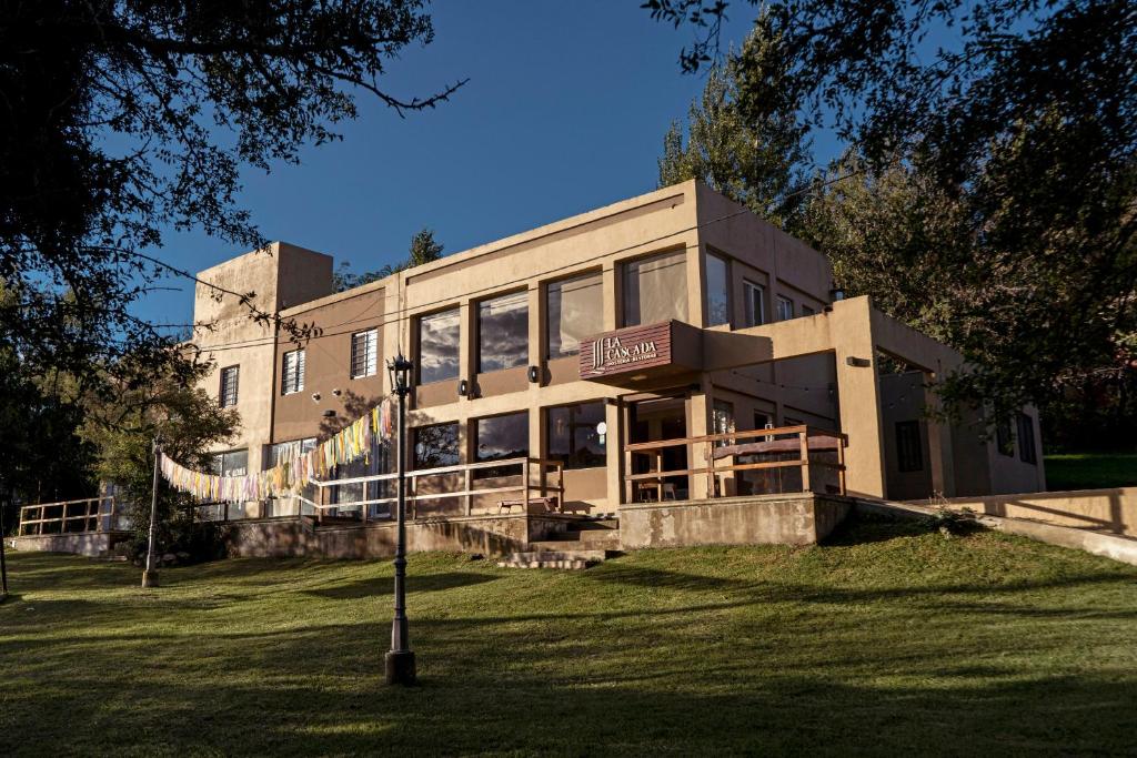a large building on a grass field with a street light at Hostería La Cascada in Alpa Corral