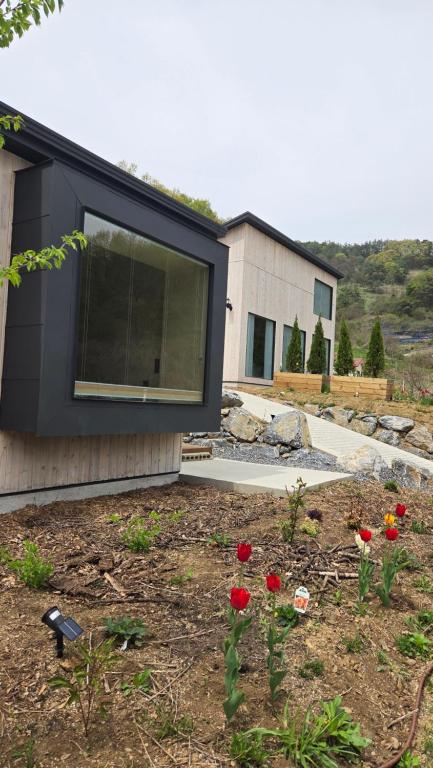 a house with a window on the side of it at 산골민박수페쉼 in Jecheon