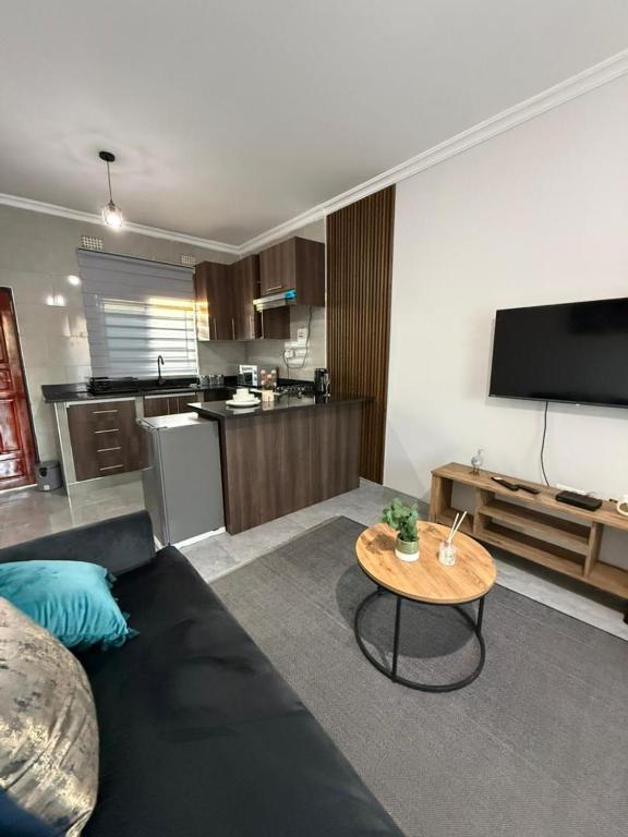 a living room with a couch and a table at WN Apartments in Lusaka