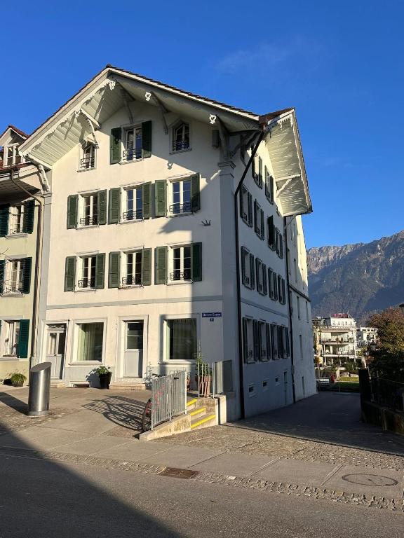 a large white building with a lot of windows at Nimbuzzz Apartments in Unterseen