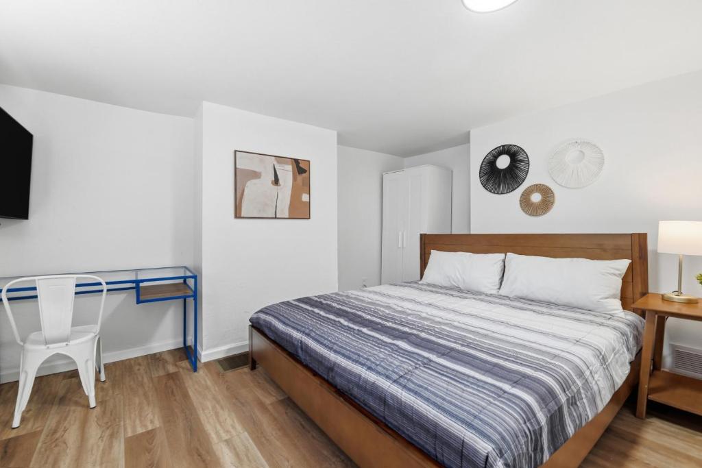 a bedroom with a bed and a desk and a television at Pittsburgh Millvale A Bright & Cozy Private Bedroom with Shared Bathroom in Pittsburgh