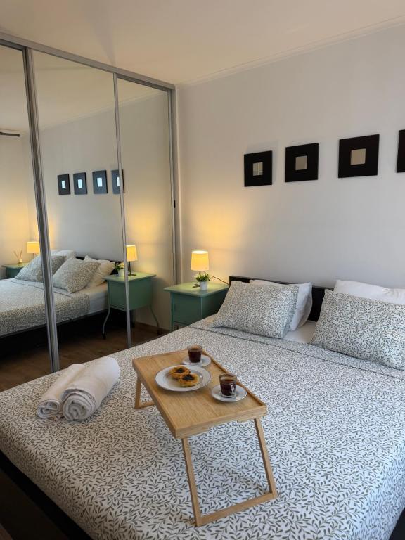 a room with two beds with a table on it at Suites Setúbal - River View in Setúbal