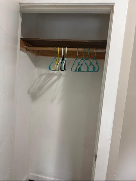 a closet with a bunch of scissors on a shelf at Anne Room B in Irvington