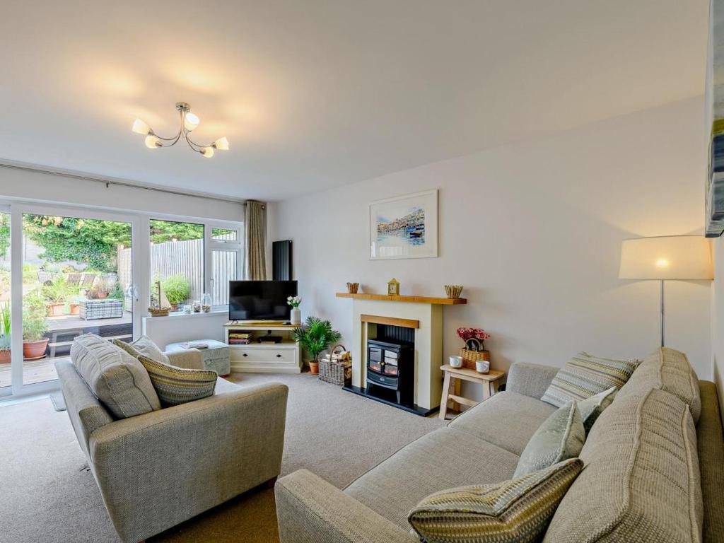 a living room with two couches and a fireplace at 3 Bed in Brixham oc-92770 in Brixham