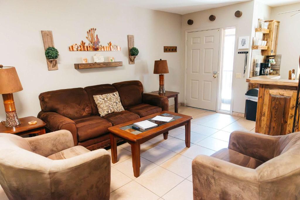 a living room with a couch and a table at Desert Oasis Condo in Green Valley