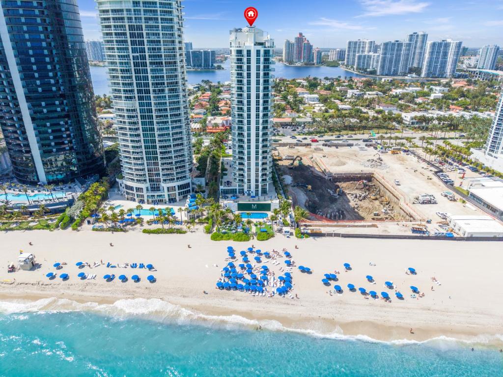 an aerial view of a beach with umbrellas and buildings at Oceanview Apt Marenas Resort, Direct Beach Access! in Sunny Isles Beach