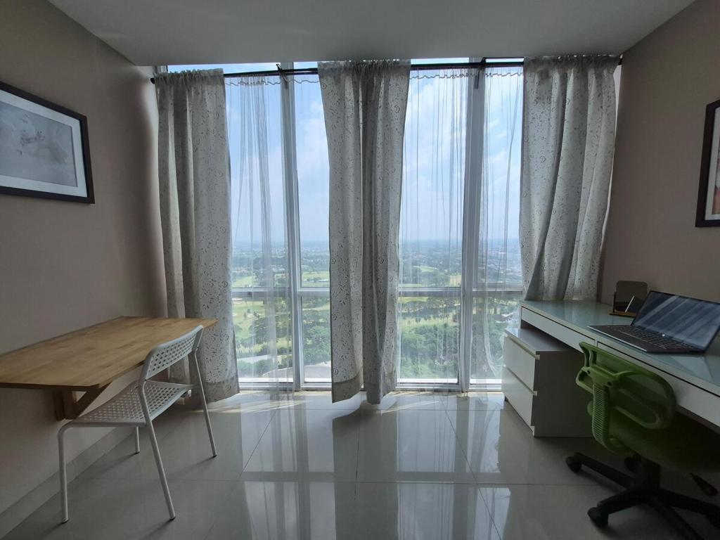 an office with a desk and a table and windows at Cozy 1BR UResidence 2 by REJA Essentials in Klapadua