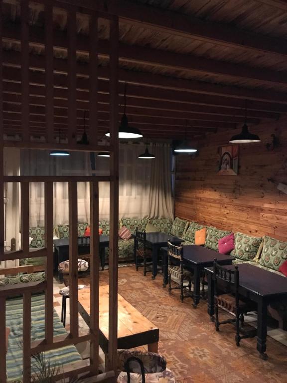 a living room with couches and tables in a building at Hôtel Riad Gnaoua in Essaouira