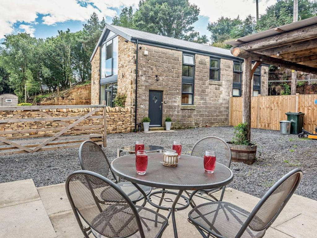 a patio with a table and chairs in front of a building at 2 Bed in Sheffield oc-92978 in Langsett