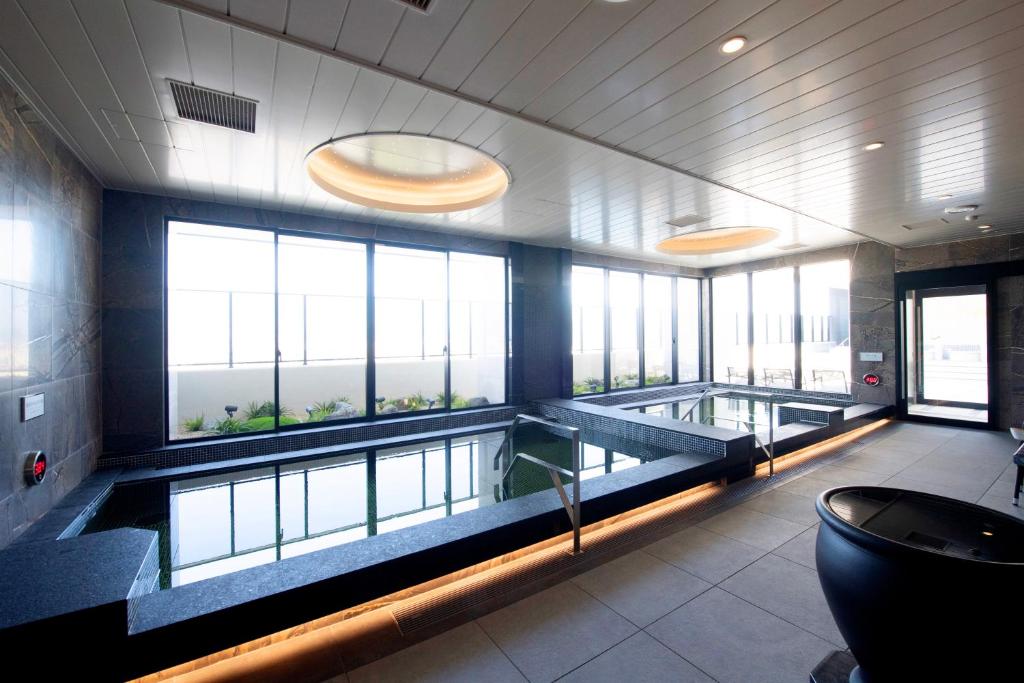 a large room with a swimming pool in a building at THE RISE Osaka Universal Bayside in Osaka