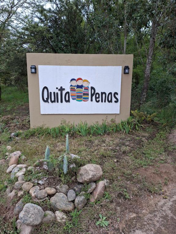 a sign for a quilla panas sign in a field at Quita penas in Los Reartes