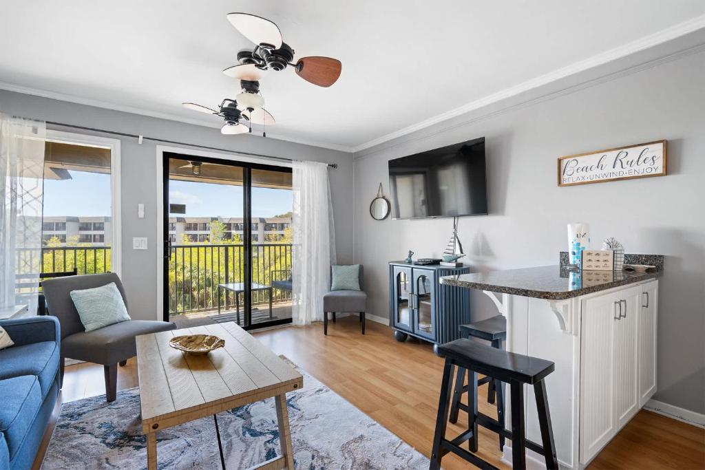 a living room with a couch and a table at New Listing - Spring Discounts Beach View Condo in Hilton Head Island
