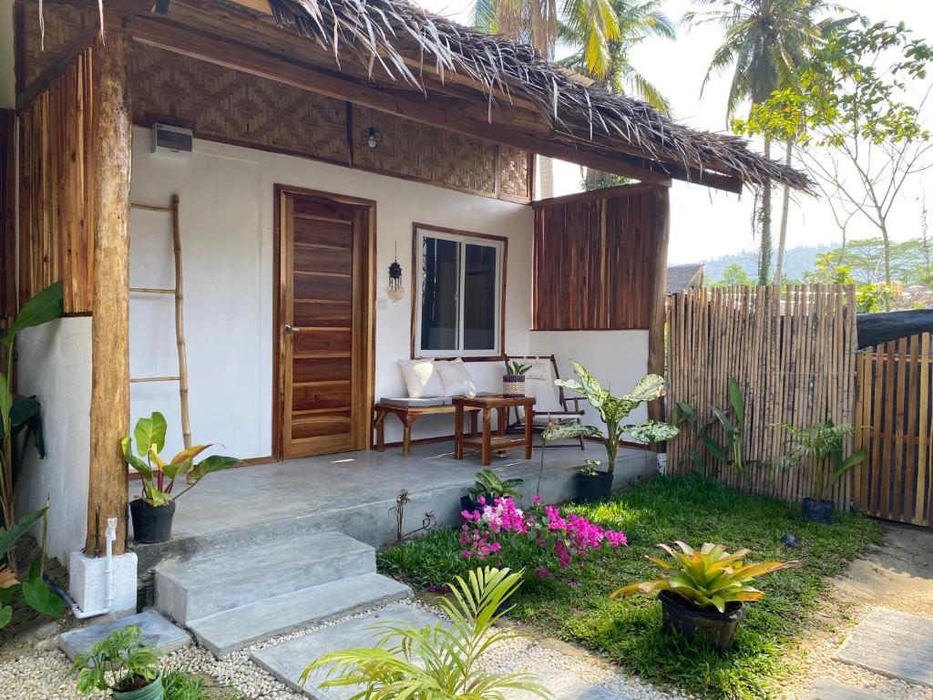 a patio of a house with a table and chairs at Sunset Garden in San Vicente