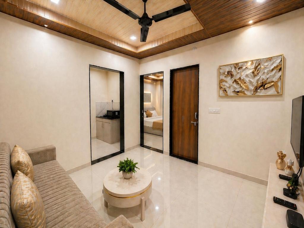 a living room with a couch and a table at Hotel Aventus Suites Indore in Indore