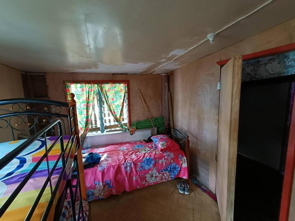 a small room with a bed and a window at Phantom rock view homestay in Namara