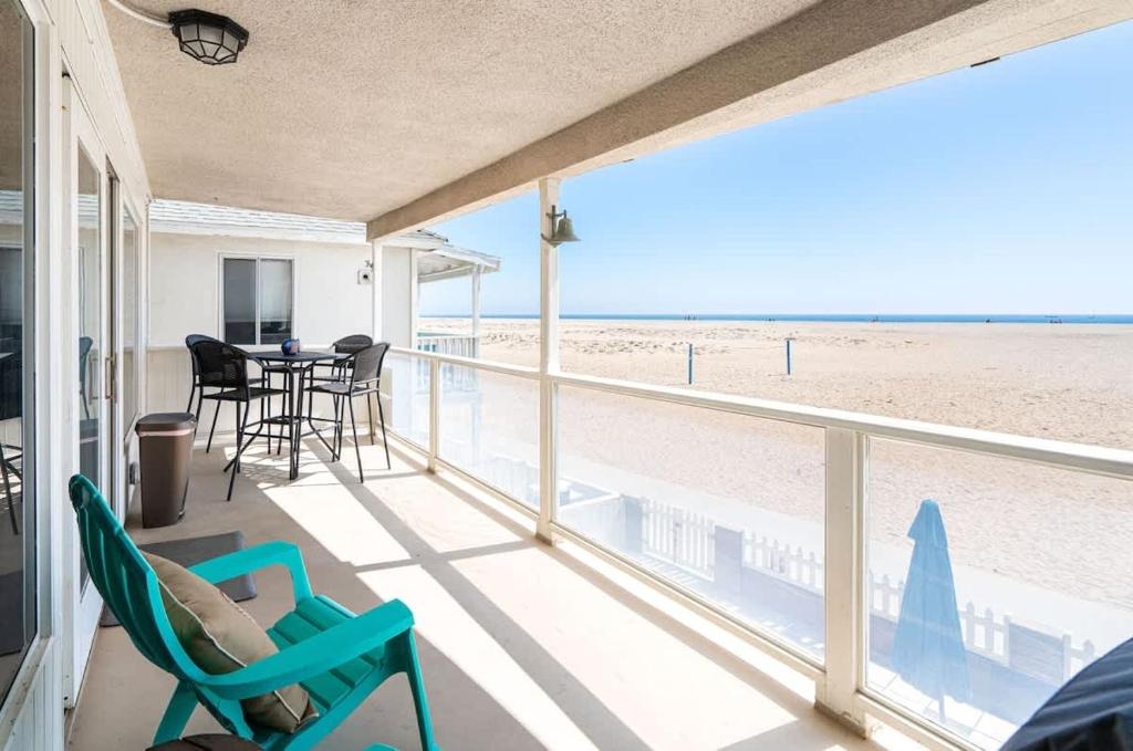 a room with a balcony with a view of the beach at 1005 East Balboa in Newport Beach