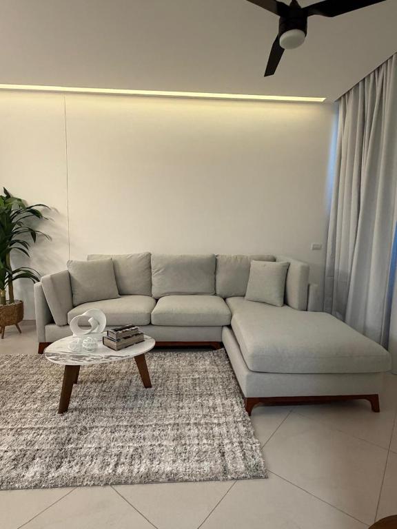 a living room with a couch and a coffee table at Paradise in a rainforest reserve B 503 in Playa del Carmen