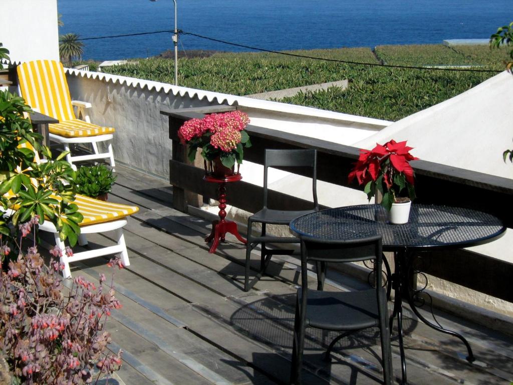 a patio with a table and chairs and the ocean at Casa Coronela in Garachico