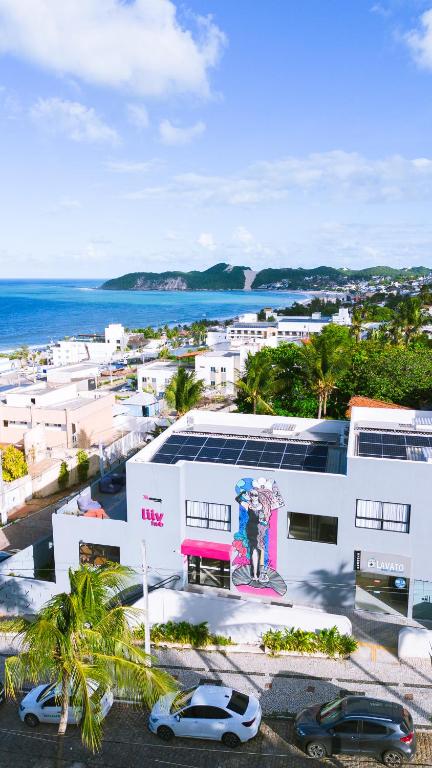 an aerial view of a building with cars parked in a parking lot at Liiv Hub - Natal PontaNegra in Natal