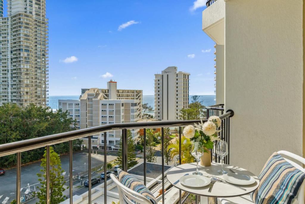a balcony with a table and chairs and a view of the city at Ocean View Suite 2 Beds Wi-Fi Netflix in Gold Coast