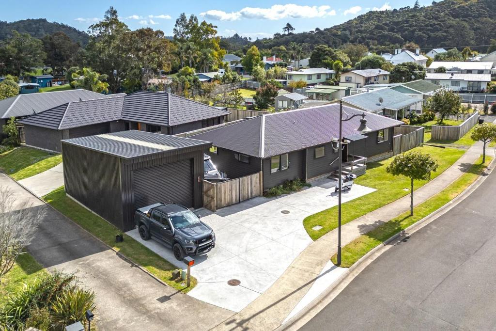 an overhead view of a house with a truck parked in a driveway at The Bach in Coromandel Town