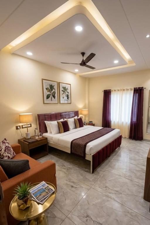 a bedroom with a large bed and a couch at Raman Resort Hotel and Banquet in Gagargārh