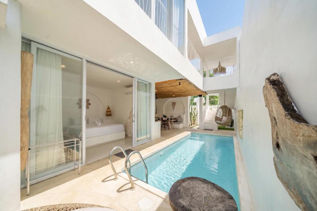 an indoor swimming pool in a house at Casa Sud - Secluded Pool Villa in Uluwatu in Uluwatu