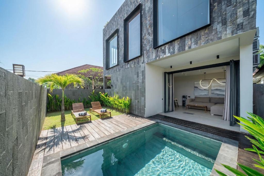 a swimming pool in the backyard of a house at Grey Stones - Private Pool Villa with Rooftop in Ungasan