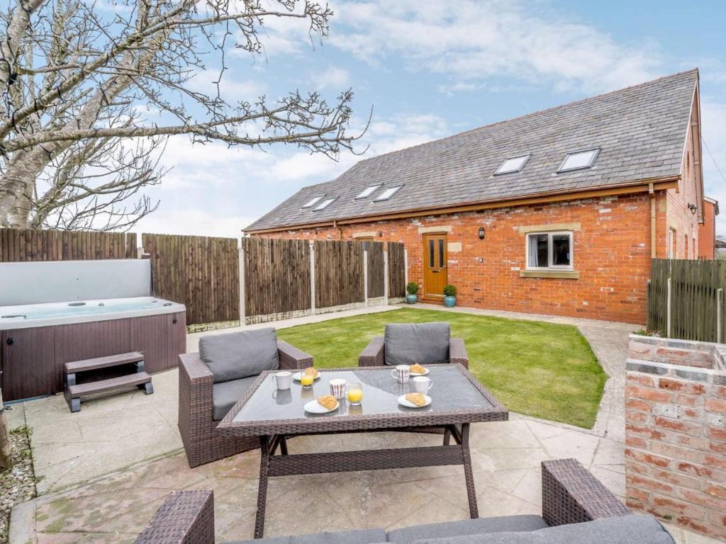 a patio with a table and chairs in a yard at 3 Bed in Poulton-le-fylde oc-41764 in Preesall
