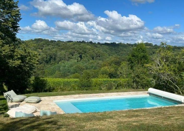 a swimming pool in the middle of a yard at Maison du causit in Aubertin