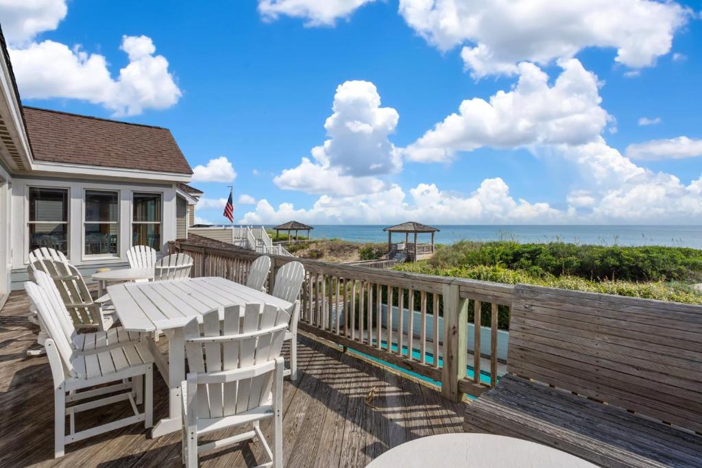 a deck with a table and chairs and the ocean at 6120 - Yankee Clipper in Nags Head