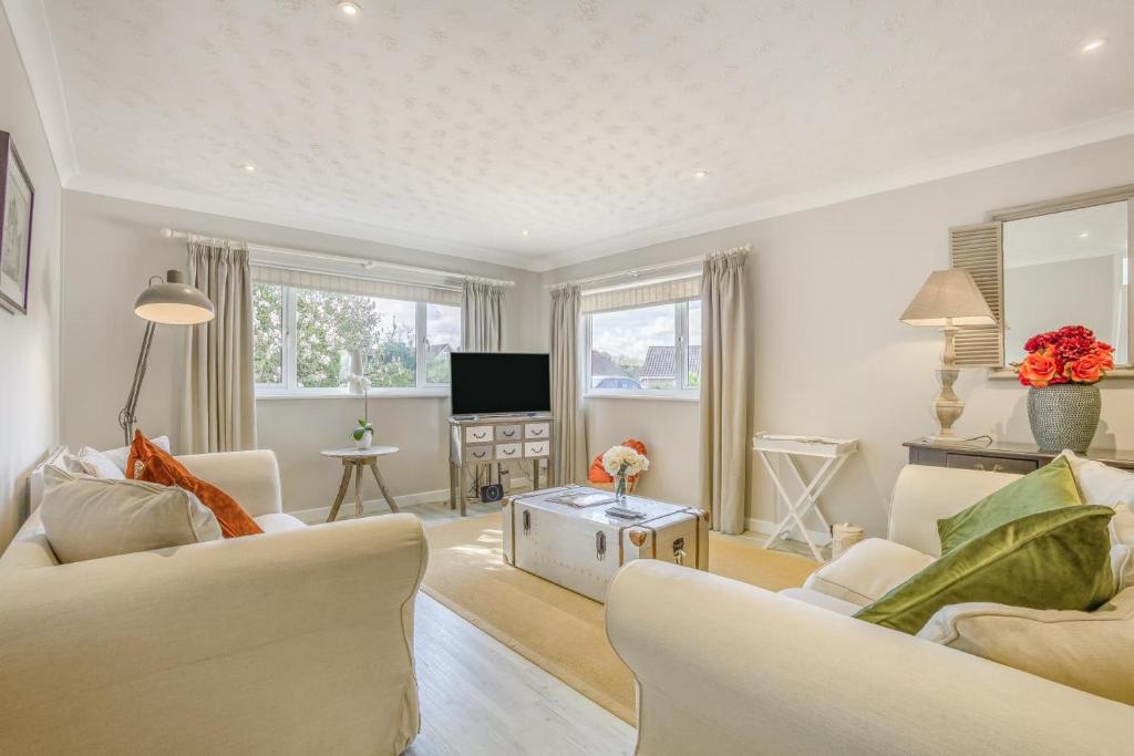 a living room with two white couches and a television at 2 Bed in Halesworth oc-dak in Halesworth