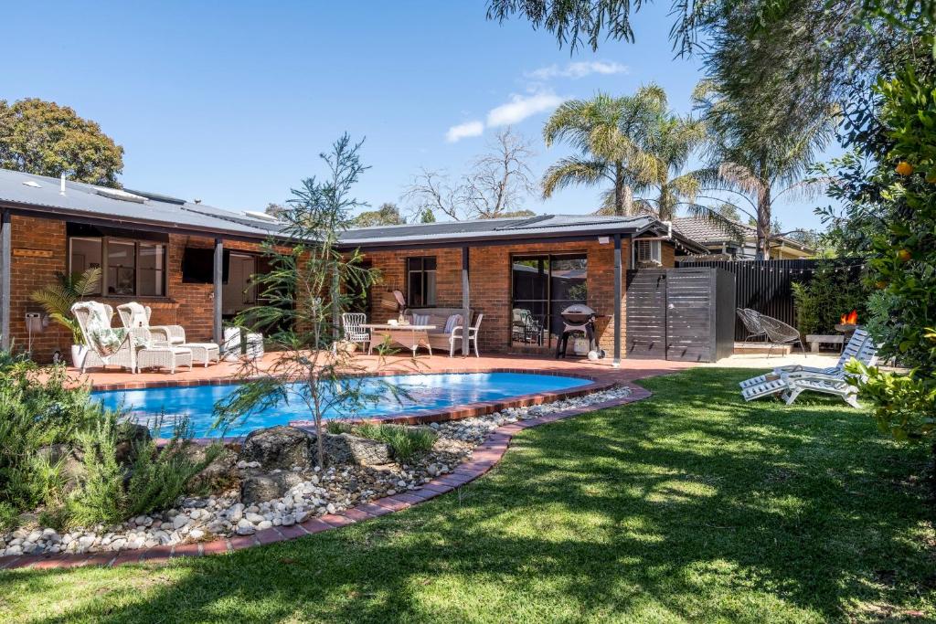 a house with a swimming pool in a yard at The Pool House in Rosebud