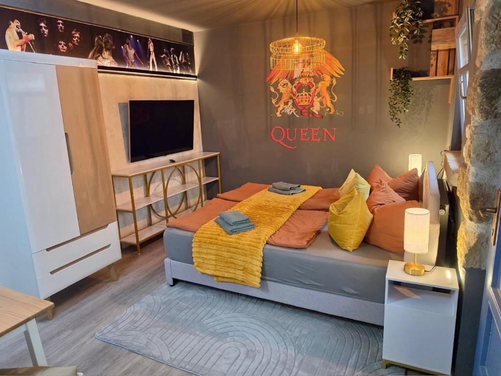 a bedroom with a large bed and a television at Gemütliches Studio in Dresden-zentrumsnah in Dresden
