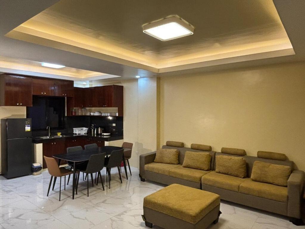 a living room with a couch and a table and chairs at Three Bedrooms Two Storey Home with Parking in Santa Rosa