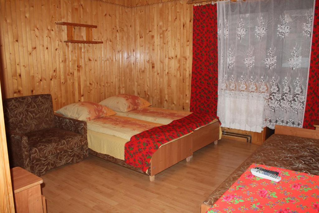 ザコパネにあるPokoje Zakopaneの小さなベッドルーム(ベッド1台、椅子付)