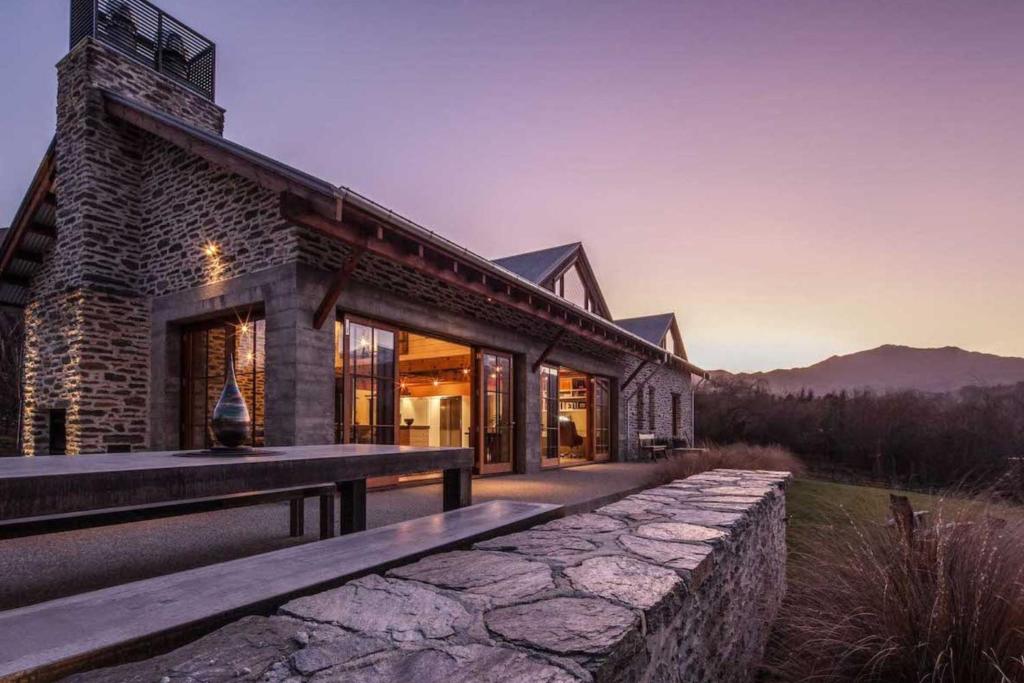 a house with a stone walkway in front of it at Toi Point Lodge in Queenstown
