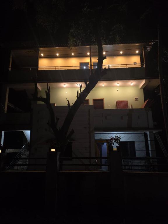 a building with lights on it at night at Ocean Mist Beach Homestay in Māvalli