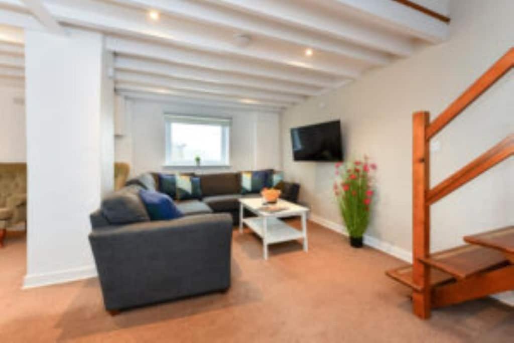 a living room with a couch and a table at Rhiw in Llangian