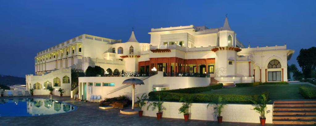 a large white building with a pool in front of it at Noor-Us-Sabah Palace in Bhopal