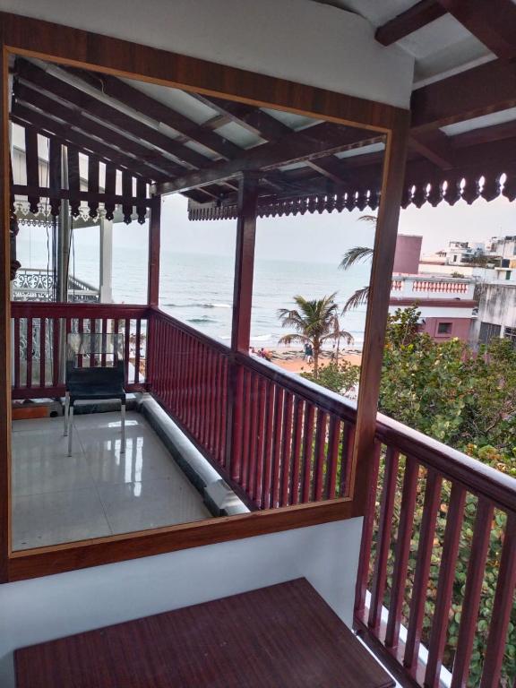 a balcony with a view of the beach at Ajantha Beach Guest House in Pondicherry