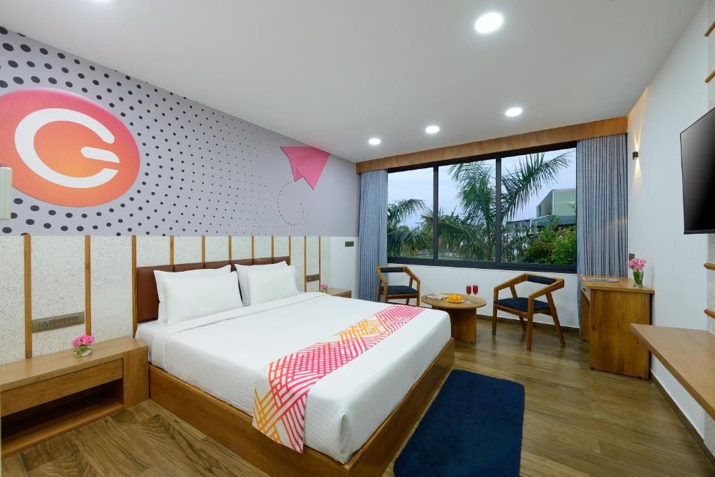 a hotel room with a bed and a tv at Ginger Kheda, Ahmedabad in Kheda