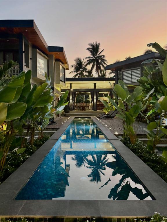 a swimming pool in front of a house at Islaya Siargao on Opening Phase in General Luna