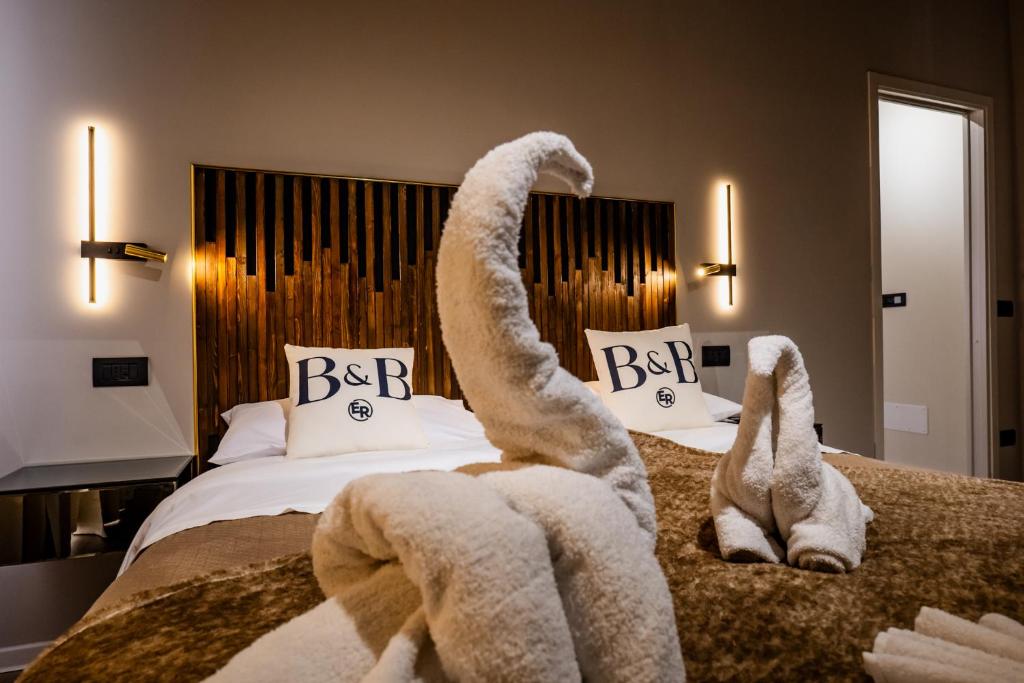 a bedroom with a bed with towel animals on it at B&B er in Isola del Liri