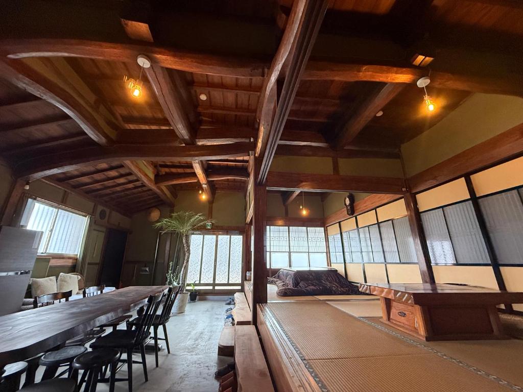 a large room with a long table and chairs at ゐらくさ in Yaizu