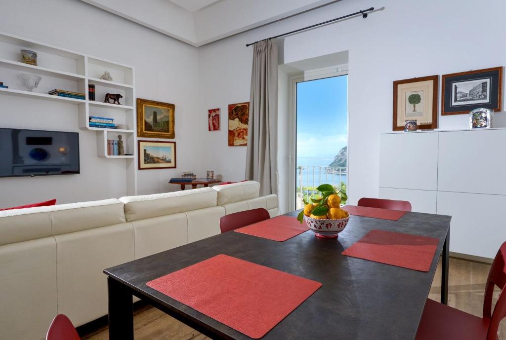 a living room with a table and a couch at La casa di Mimí in Vico Equense