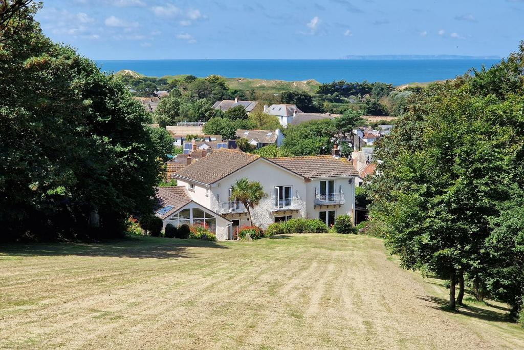 a house on a hill with a grass field at Croft House in Croyde