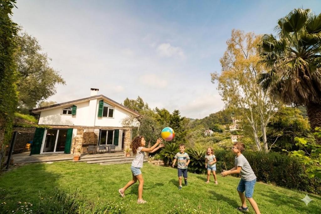 a group of people playing with a ball in a yard at Casa Liselotte in Imperia